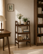 3-tier walnut ladder shelf in a sunlit room beside an oak desk